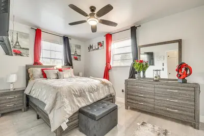 a bedroom with a bed and a ceiling fan at 3 Mi to Port Everglades Modern Getaway with Yard in Dania Beach