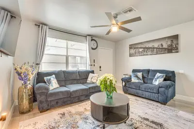 a living room with a couch and a table at 3 Mi to Port Everglades Modern Getaway with Yard in Dania Beach