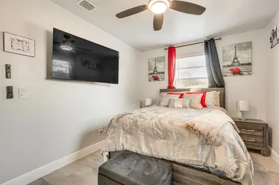 a bedroom with a bed and a ceiling fan at 3 Mi to Port Everglades Modern Getaway with Yard in Dania Beach