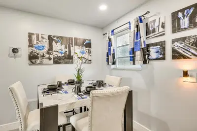 a dining room with a table and chairs at 3 Mi to Port Everglades Modern Getaway with Yard in Dania Beach