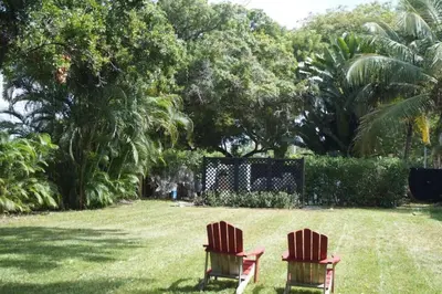 two chairs sitting in the grass in a yard at Historic Sailboat Bend Home 5 Min to Las Olas 4 miles to the Beach in Fort Lauderdale