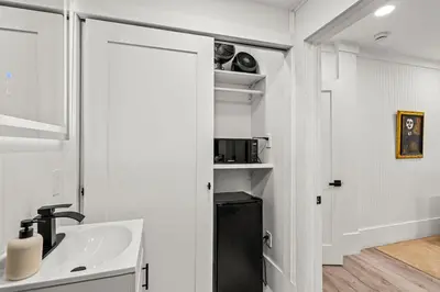 a white bathroom with a sink and a mirror at Newly Renovated Home- Sailboat Bend - Walk to Las Olas - 4 Miles to Beach in Fort Lauderdale