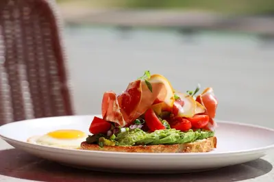 a plate of food with an egg and a sandwich at Cardozo Hotel in Miami Beach