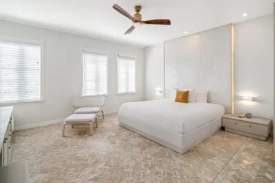 a white bedroom with a bed and a ceiling fan at Cardozo Hotel in Miami Beach