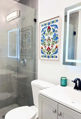 a bathroom with a shower and a toilet and a sink at Cloud Nine - Wilton Drive Jacuzzi Backyard in Fort Lauderdale