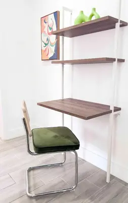 a chair in front of a wall with shelves at Cloud Nine - Wilton Drive Jacuzzi Backyard in Fort Lauderdale