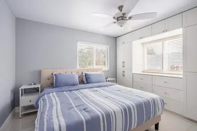a bedroom with a bed and a ceiling fan at 4 BR home with private pool in Fort Lauderdale