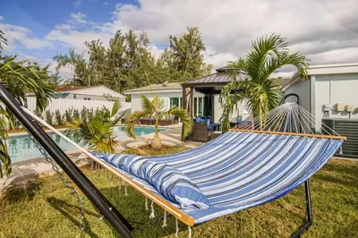 a blue hammock in a yard next to a pool at 4 BR home with private pool in Fort Lauderdale