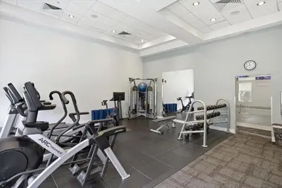 a gym with several treadmills and exercise bikes at Spacious 1BR Loft Villa - Pool Golf - Doral Downtown in Miami