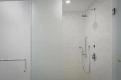 a bathroom with a shower with a glass door at Spacious 1BR Loft Villa - Pool Golf - Doral Downtown in Miami