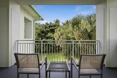 two chairs and a table on a balcony at Spacious 1BR Loft Villa - Pool Golf - Doral Downtown in Miami