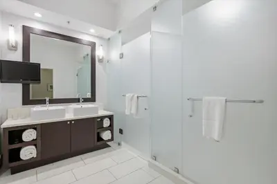 a white bathroom with a sink and a shower at Spacious 1BR Loft Villa - Pool Golf - Doral Downtown in Miami
