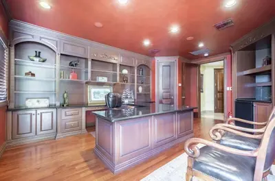 a kitchen with a large island in a room with wooden walls at Serene 7000 SF Gated Luxury Waterfront Home in Fort Lauderdale