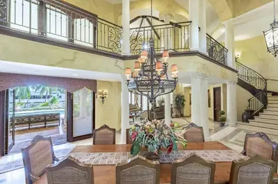 a large dining room with a table and a chandelier at Serene 7000 SF Gated Luxury Waterfront Home in Fort Lauderdale