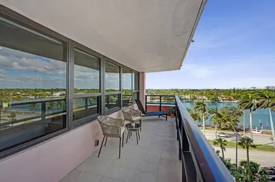 a balcony with chairs and a view of the water at Bright 3BR 3BA Condo with Stunning Bay Views in Oceanfront Complex 820 in Miami Beach