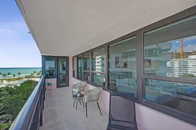 a balcony of a house with a view of the ocean at Bright 3BR 3BA Condo with Stunning Bay Views in Oceanfront Complex 820 in Miami Beach
