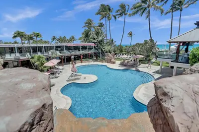 a swimming pool at a resort with palm trees at Bright 3BR 3BA Condo with Stunning Bay Views in Oceanfront Complex 820 in Miami Beach