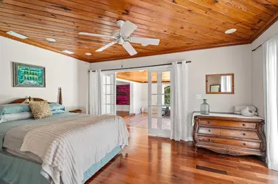 a bedroom with a ceiling fan and a bed at Brazilian Style Getaway 2 Minutes to Beach in Hollywood