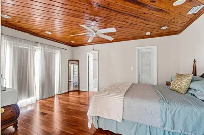 a bedroom with a ceiling fan and a bed at Brazilian Style Getaway 2 Minutes to Beach in Hollywood