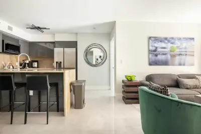 a kitchen and living room with a couch and a table at The Yacht Club at Aventura Miami 8304 in Aventura