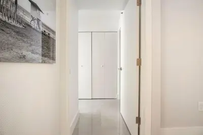 a hallway with white walls and a door to a closet at The Yacht Club at Aventura Miami 8304 in Aventura