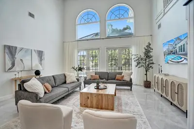 a living room with a couch and a table at 6BR Elegant Hollywood Lakes Mansion with Private Pool & Spa in Hollywood