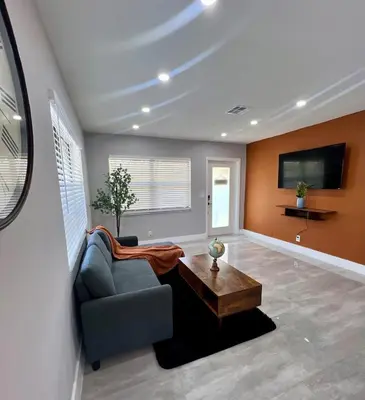 a living room with a couch and a coffee table at 20 OFF Golden Hour BBQ 10 MIN Beach Airport FL in Fort Lauderdale