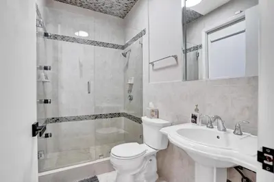a bathroom with a toilet and a sink and a shower at 6BR Elegant Hollywood Lakes Mansion with Pool & Spa home in Hollywood