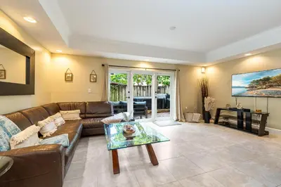 a living room with a couch and a table at Salty Fox 5BD Oasis w Spa, Beach & Downtown in Fort Lauderdale