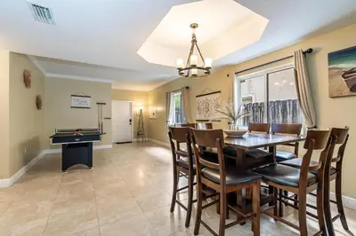 a dining room with a table and a pool table at Salty Fox 5BD Oasis w Spa, Beach & Downtown in Fort Lauderdale