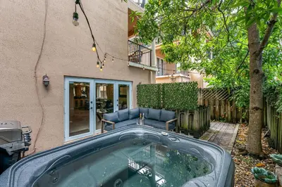 a hot tub in a yard next to a building at Salty Fox 5BD Oasis w Spa, Beach & Downtown in Fort Lauderdale