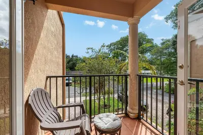 a balcony with two chairs and a table at Salty Fox 5BD Oasis w Spa, Beach & Downtown in Fort Lauderdale