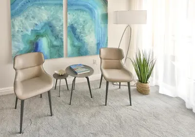 two chairs and a table in a room with a painting at Luxury Studio at The Ritz-Carlton Key Biscayne in Miami