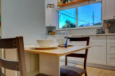 a kitchen with a table and chairs and a window at Private Retreat with Yard Near Hard Rock Stadium in Miramar