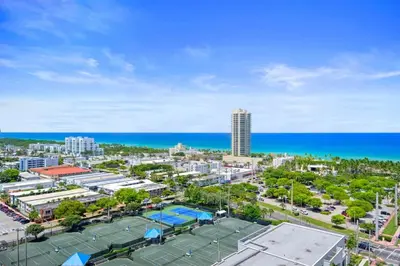 a tennis court with the ocean in the background at NOK Amazing 1 BR in Miami Beach in Miami Beach