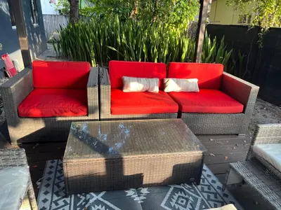 a red couch sitting on a patio with a table at Modern 2 BR near shops, WD fast WiFI 2000mbps 10 min to beach Bliss 7 in Hollywood