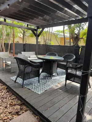 a patio with a table and chairs on a wooden deck at Modern 2 BR near shops, WD fast WiFI 2000mbps 10 min to beach Bliss 7 in Hollywood