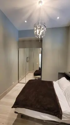 a bedroom with a large bed and a chandelier at South Beach Luxury 2 Bedroom Condo on the Ocean in Miami Beach