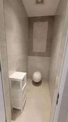 a bathroom with a white toilet and a sink at South Beach Luxury 2 Bedroom Condo on the Ocean in Miami Beach