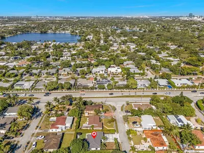 an aerial view of a suburb with a road and a lake at Azure Coastal Breeze in North Miami Beach