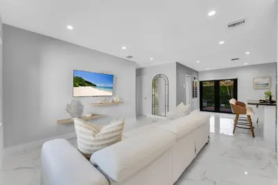 a white living room with a white couch at Azure Coastal Breeze in North Miami Beach