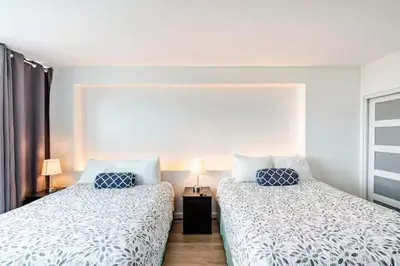 two beds sitting next to each other in a bedroom at A dreamed bay view studio at Castle Beach Club in Miami Beach
