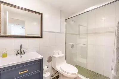 a bathroom with a shower and a toilet and a sink at A dreamed bay view studio at Castle Beach Club in Miami Beach