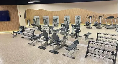 a gym with rows of chairs and tread machines at A dreamed bay view studio at Castle Beach Club in Miami Beach