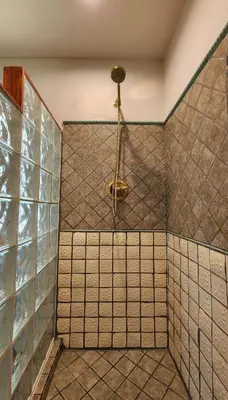 a bathroom with a shower with a shower head at LUSH TROPICAL STUDIO in FT LAUDEDALE'S HISTORICAL SAILBOAT BEND NEIGHBORHOOD in Fort Lauderdale