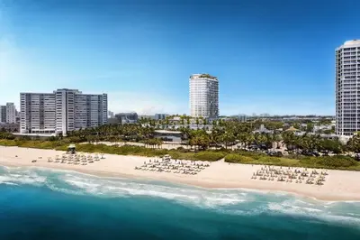 an aerial view of a beach with chairs and the ocean at 72 Park- Luxury Condo With Private Beach Access in Miami Beach
