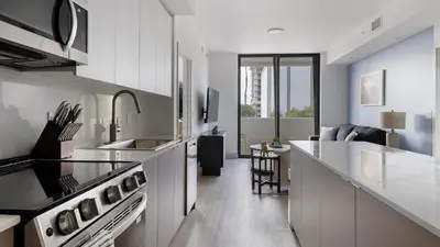 a kitchen with white cabinets and a counter top at Landing Chic 2BD Clubhouse Yoga Studio in North Miami