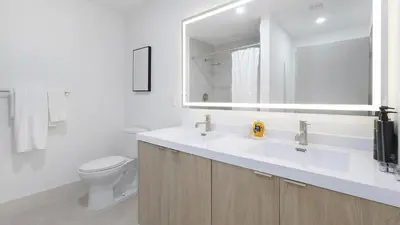 a white bathroom with a sink and a toilet at Landing Chic 2BD Clubhouse Yoga Studio in North Miami
