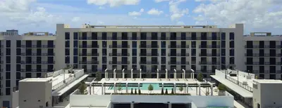 a large white building with a pool in front of it at Landing Chic 2BD Clubhouse Yoga Studio in North Miami