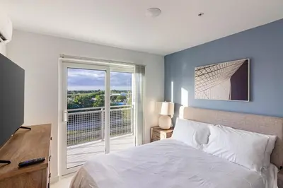 a bedroom with a bed and a large window at Landing Incredible 3BD Pool Gym in Naranja
